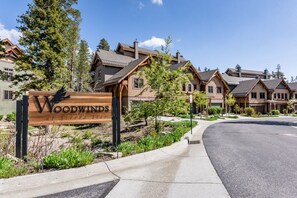 Welcome to Woodwinds at Sierra Ski Resort, where modern homes with pitched roofs are nestled among well-maintained landscaped greenery.