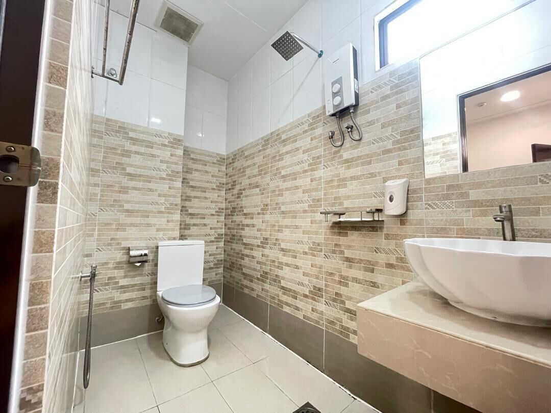 Une salle de bain avec des toilettes, une douche et un lavabo.