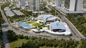 Un complexe moderne composé de plusieurs bâtiments, dont une grande structure circulaire et un bâtiment en forme de dôme, le tout entouré d’espaces verts et de routes.