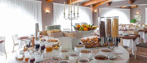 A breakfast buffet with various food items and beverages.