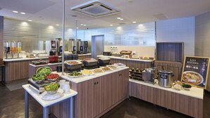 A modern kitchen area with a buffet setup, including various food stations and a live kitchen sign. - Keio Presso Inn Otemachi (Tokyo)