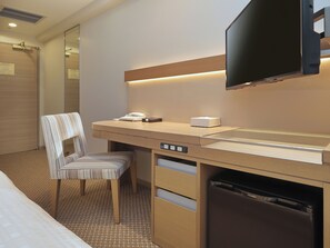 A hotel room with a bed, a desk with a telephone, a chair, a television mounted on the wall, and a built-in dishwasher. - Keio Presso Inn Otemachi (Tokyo)