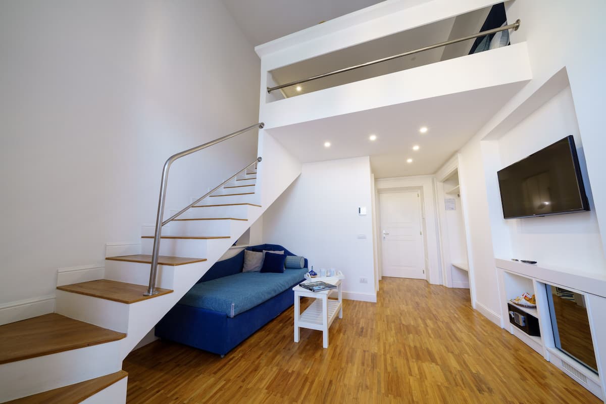 Familie suite, balkon | Luxe beddengoed, donzen dekbedden, een minibar, een kluis op de kamer