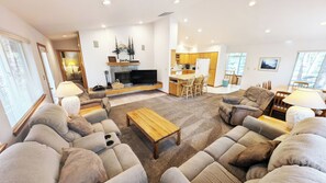 Cozy living space with a sofa set, flat-screen TV, and dining area.
