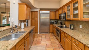A kitchen with wooden cabinets, granite countertops, stainless steel appliances, and a tiled floor. - A Beauty in Scottsdale! (Scottsdale)