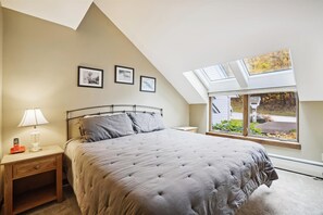 Primary Bedroom with Skylights - The primary bedroom features a comfortable bed and large skylights that fill the room with natural light.