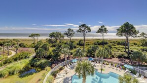 A resort with a pool area, beach view, and tropical landscaping. - Oceanfront Villa with Heated Pool! Steps to the Sand (Hilton Head Island)