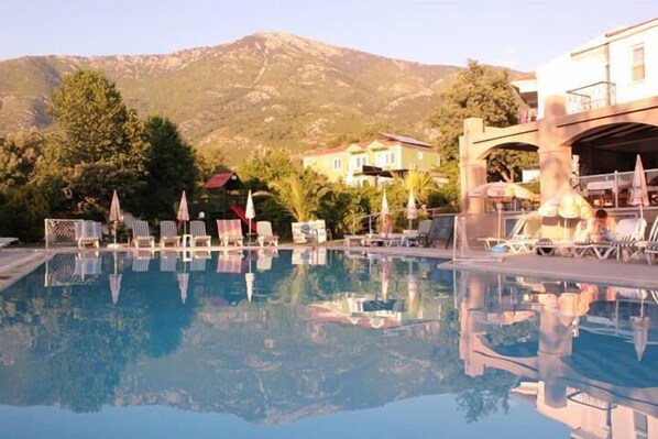 Outdoor pool, open 8:00 AM to 8:30 PM, pool loungers