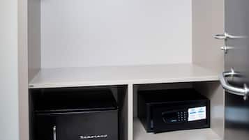A compact storage unit with shelves, a black appliance, and a microwave.