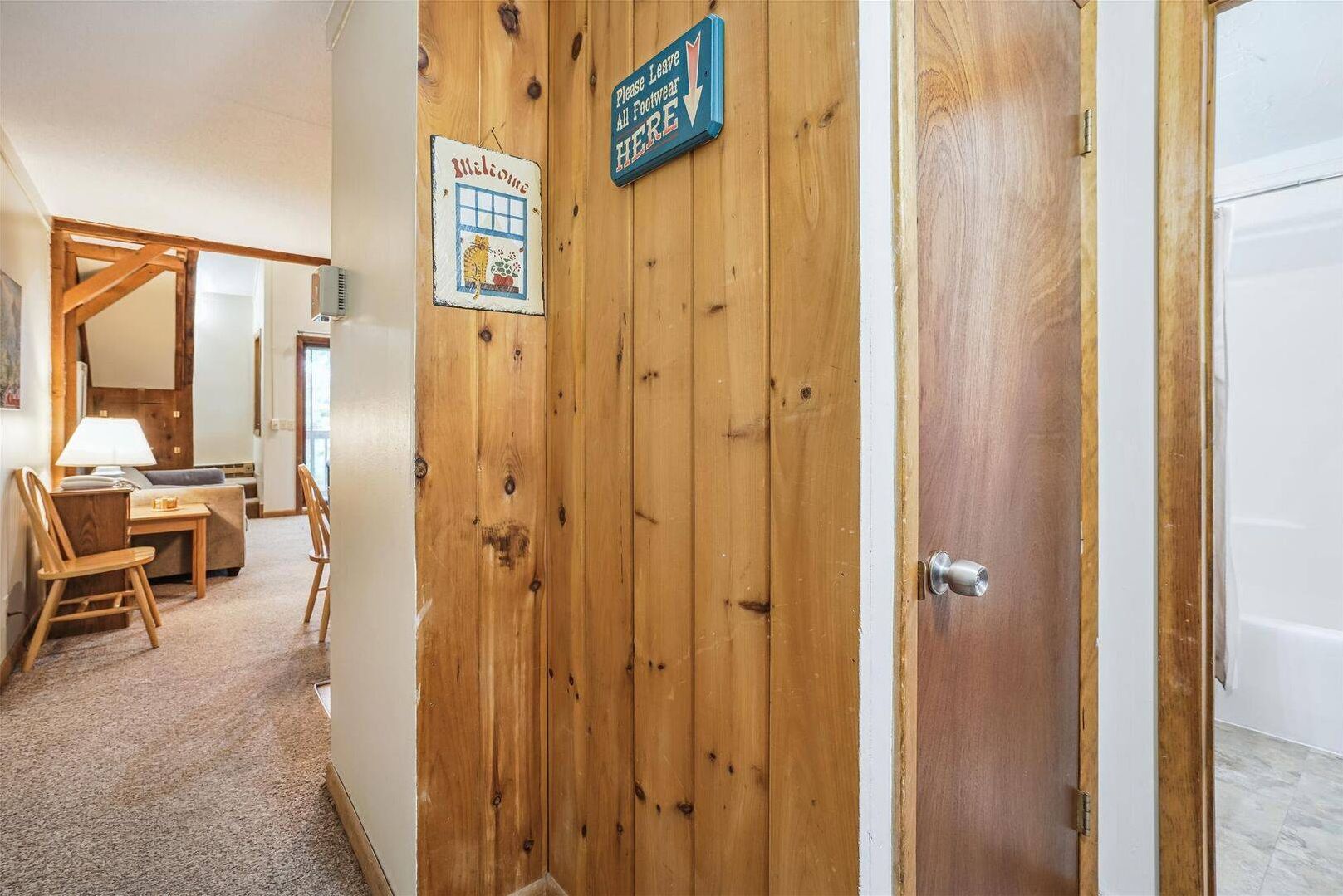 Mountain-Inspired Hallway - Warm wood accents throughout the hallway add rustic character and create a welcoming mountain lodge atmosphere.
