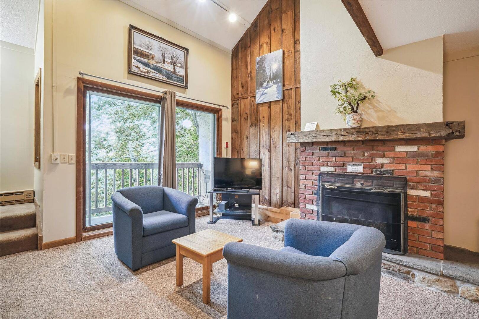 Mountain Gathering Space - The warm wood accents, soaring ceiling, and fireplace create the perfect setting to unwind after a day outdoors.