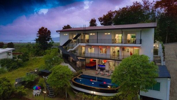 A two-story house with a swimming pool, surrounded by greenery. - Private pool villa Nap Dau Crown for Family and Friends/ Private Chef available (ต.ฉลอง)