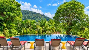 A swimming pool with lounge chairs and a view of a lush green landscape. - Villa Nap Dau Crown Private pool villa for Family and Friends (ต.ฉลอง)