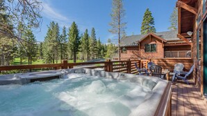 A wooden cabin with a hot tub on a deck, surrounded by trees. - Private Home with Hot Tub! Mountain Views! Short walk to Village! (Mammoth Lakes)