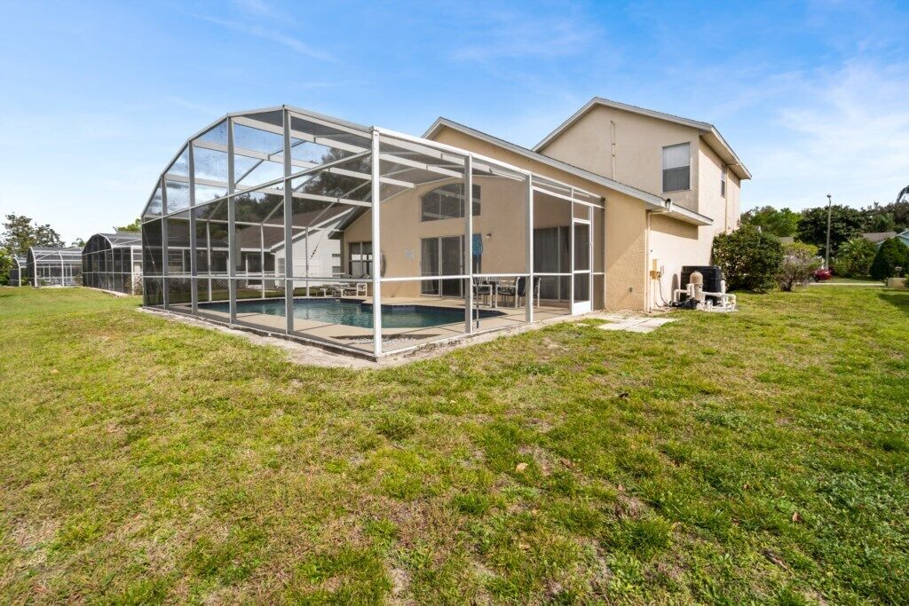 A house with a large glass-enclosed patio area.