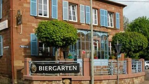 A building with a sign reading "BIERGARTEN" and a brick facade. - Hotel Gasthaus Gellenberg (Rehlingen-Siersburg)