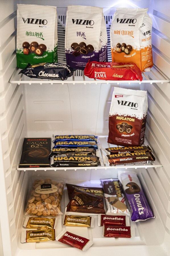 A refrigerator stocked with various chocolate and confectionery items, including brands like Vizzio and Bonafide.