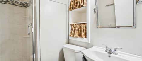Freshen Up - The updated bathroom features a walk-in tiled shower and modern finishes.