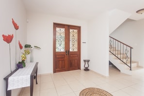 Experience a comfortable and inviting space with a dining area, staircase, and potted plant.