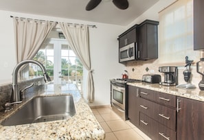 Enjoy cooking in this kitchen with an oven, microwave, and gas stove, and take in the surrounding views from the adjacent balcony.
