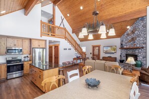 Enjoy a spacious home with a well-appointed kitchen, central island, and cozy living area featuring a fireplace.