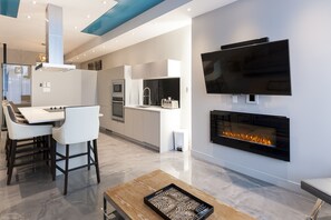 Enjoy a spacious living area with a kitchen, dining space, and fireplace.