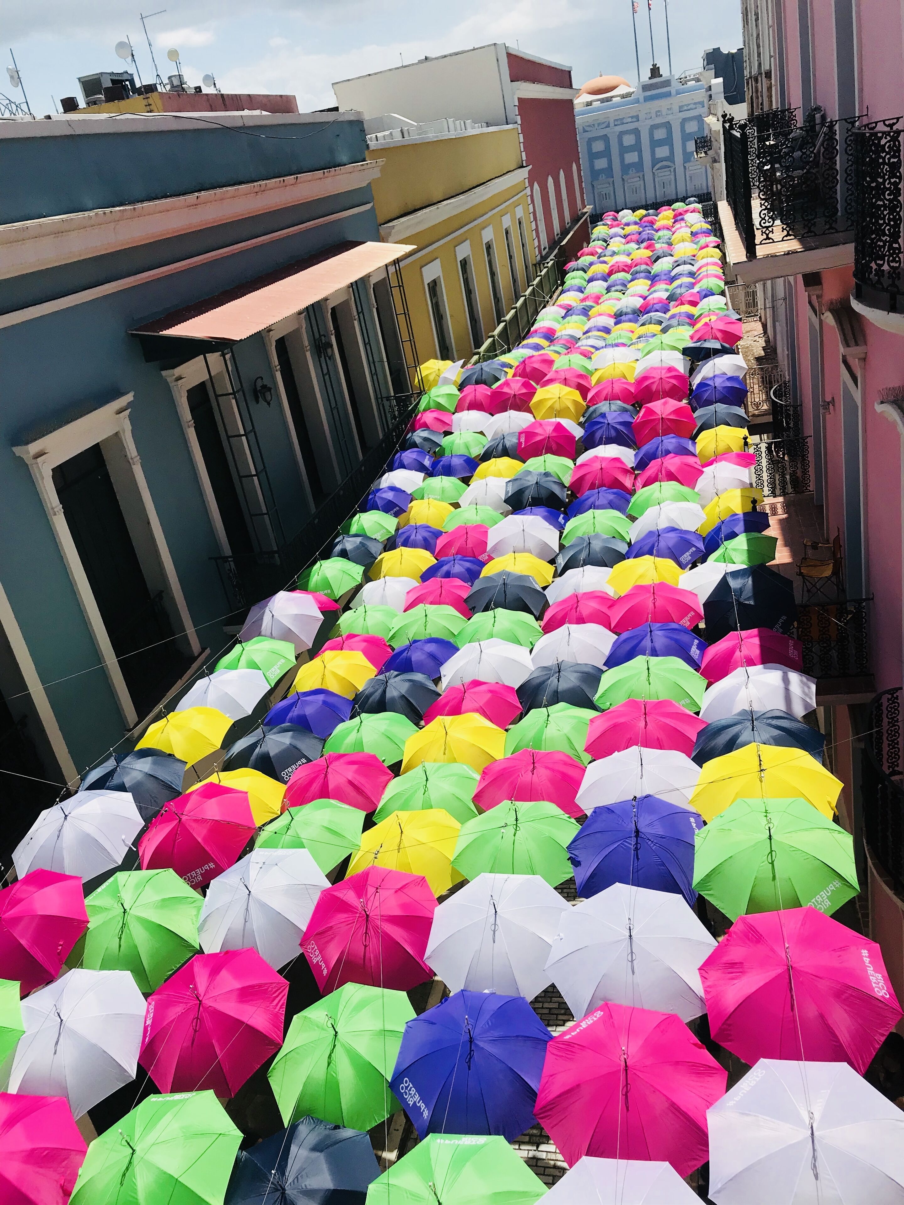 A row of colorful umbrellas on a rooftop.