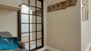 A room with a sliding door, a wooden wall decor, and a white furry rug on the floor. - 2 Bed in Ilfracombe (oc-harbh) (Ilfracombe)