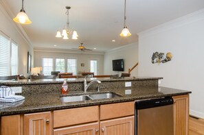 Enjoy cooking in this well-equipped kitchen with a dishwasher and stainless steel sink.