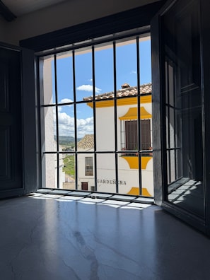 Enjoy a view of the GARDUNERA building from this room's large window.