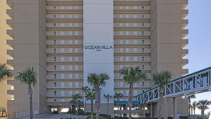 Un hôtel de grande hauteur avec une enseigne verticale au centre, sur laquelle on peut lire « OCEAN VILLA ».