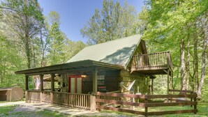 A rustic cabin with a porch, a deck, and a covered outdoor area, surrounded by trees. - Large Mountain Creek! Cabin in Tellico Plains (Tellico Plains)