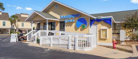 A building with a sign reading "Sandpiper Cove".