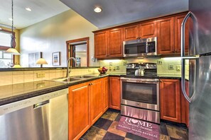 Modern kitchen with dishwasher, double oven, and microwave, offering ample cooking space.