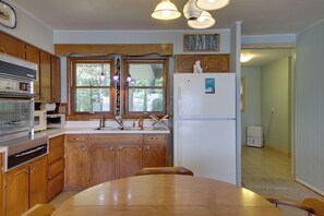 Kitchen features an oven, microwave, and sink, as well as a central island and refrigerator.