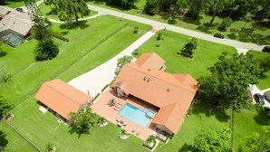 A residential property with a swimming pool, a tennis court, and a large lawn. - Spacious pool home in Wellington near WEF (Wellington)