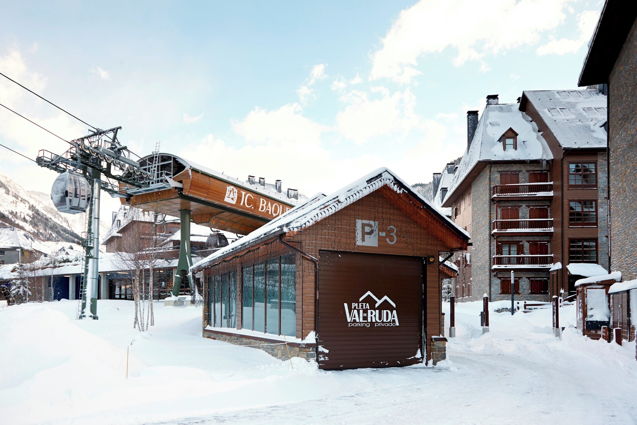 A snow-covered building with a sign reading "P-3" and "PIETA VALRUDA parking private."