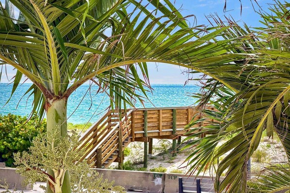 A wooden deck with a view of the ocean.