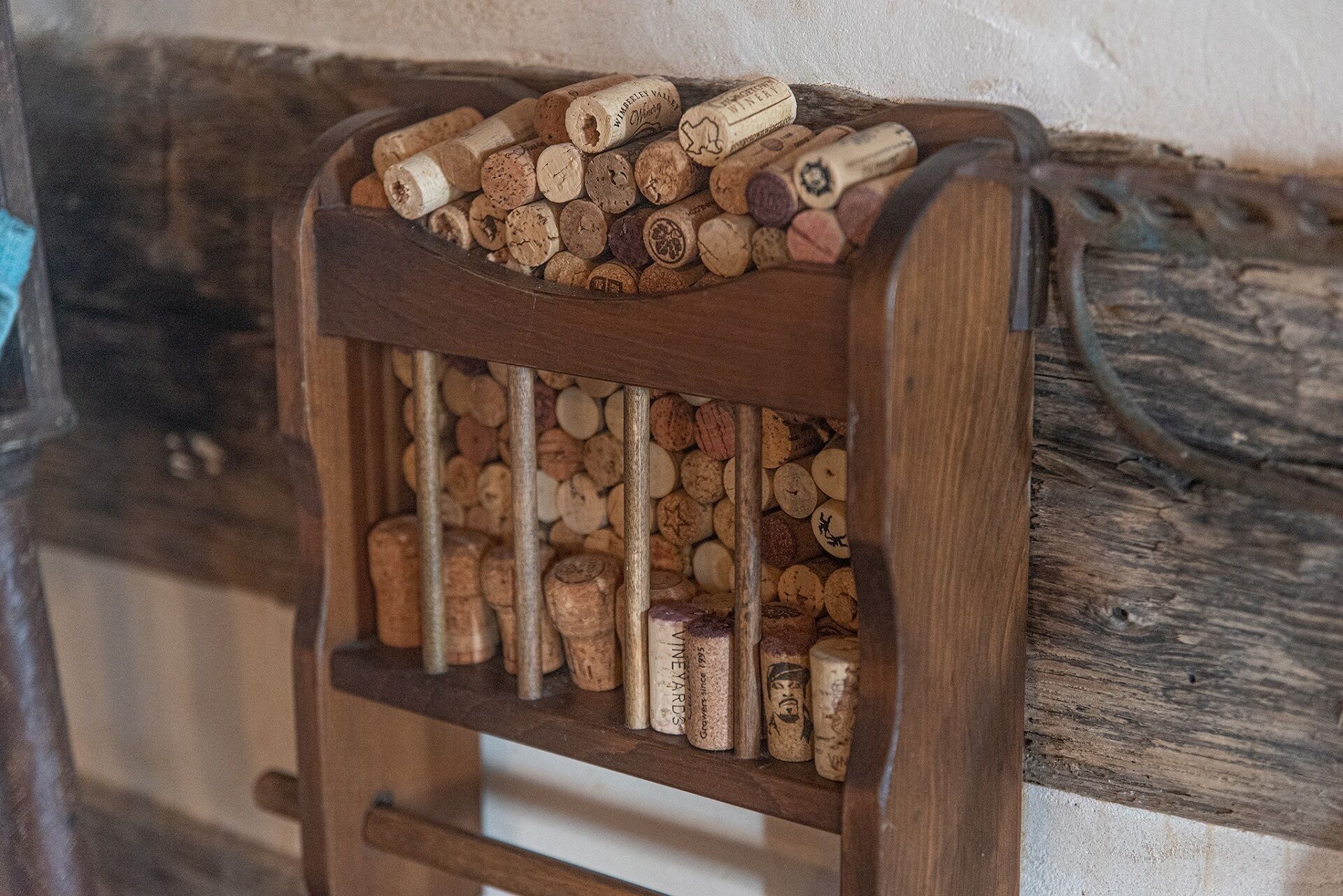 A wooden rack filled with wine corks.