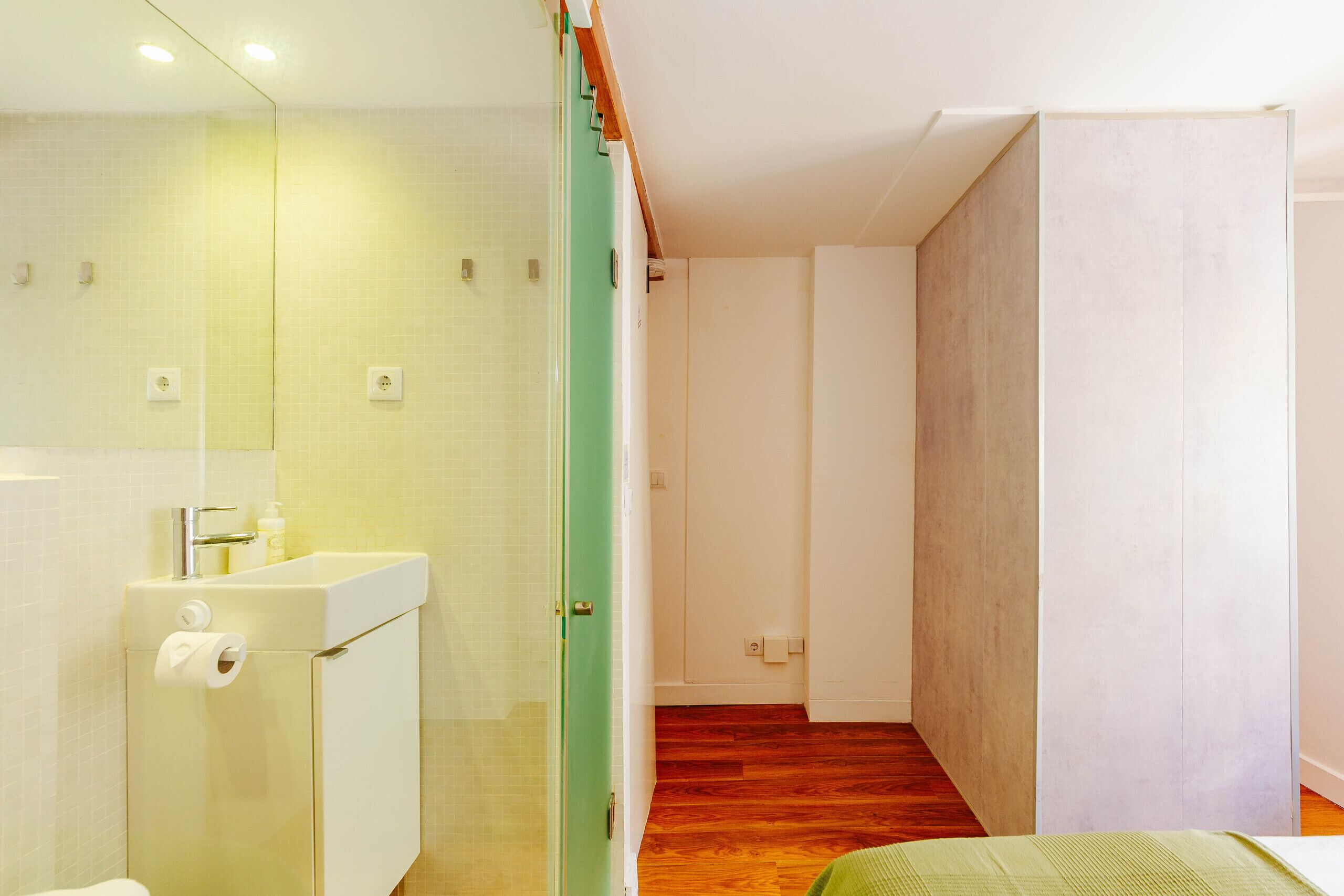 A modern bathroom with a glass shower enclosure, a toilet, and a sink.