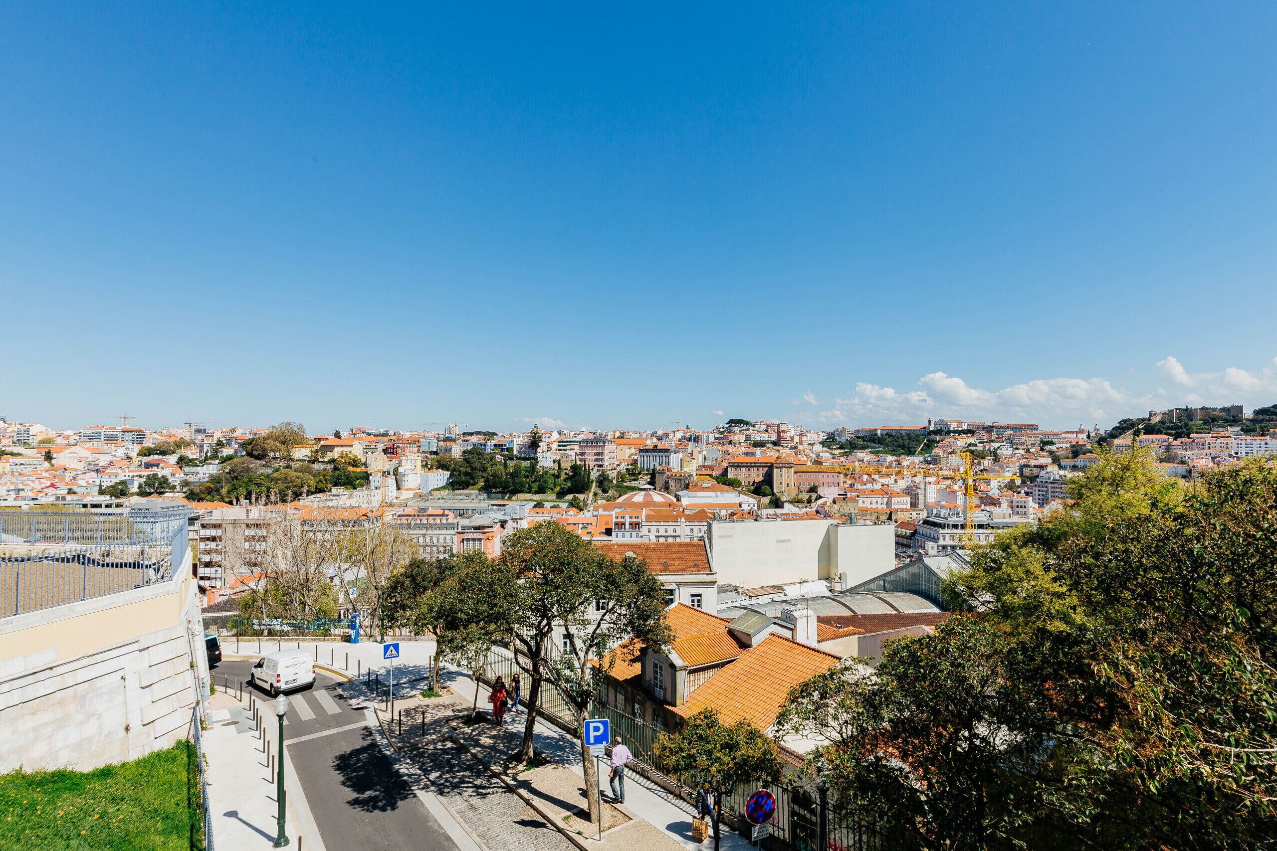 A cityscape with a mix of modern and traditional architecture, including a prominent dome and a historic building with a red roof.