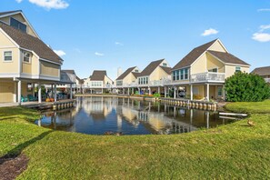 Un quartier résidentiel avec des maisons, un étang et une zone herbeuse.