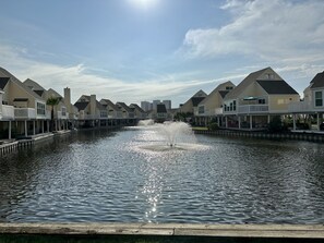Enjoy serene waterfront views from the balconies of this tranquil property, surrounded by a central water feature and access to the canal.