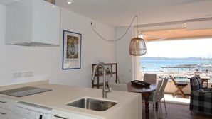 A modern kitchen with a large window overlooking a marina. - ESCORPORA (Estartit)