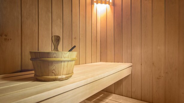 A wooden sauna bench with a wooden bucket and a brush. - Delightful 2 bedroom cottage in beautiful Devon countryside, indoor pool & sauna (Tiverton)
