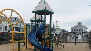 A playground with a blue slide and a yellow climbing structure. - Central AC, child safe fenced in yard, 3 minutes to the beach.  NO CLEANING FEE
 (Hampton)