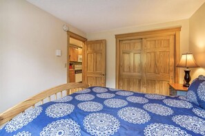 Bedroom Retreat - Warm wood furnishings and a peaceful atmosphere create a welcoming space for a restful night's sleep.