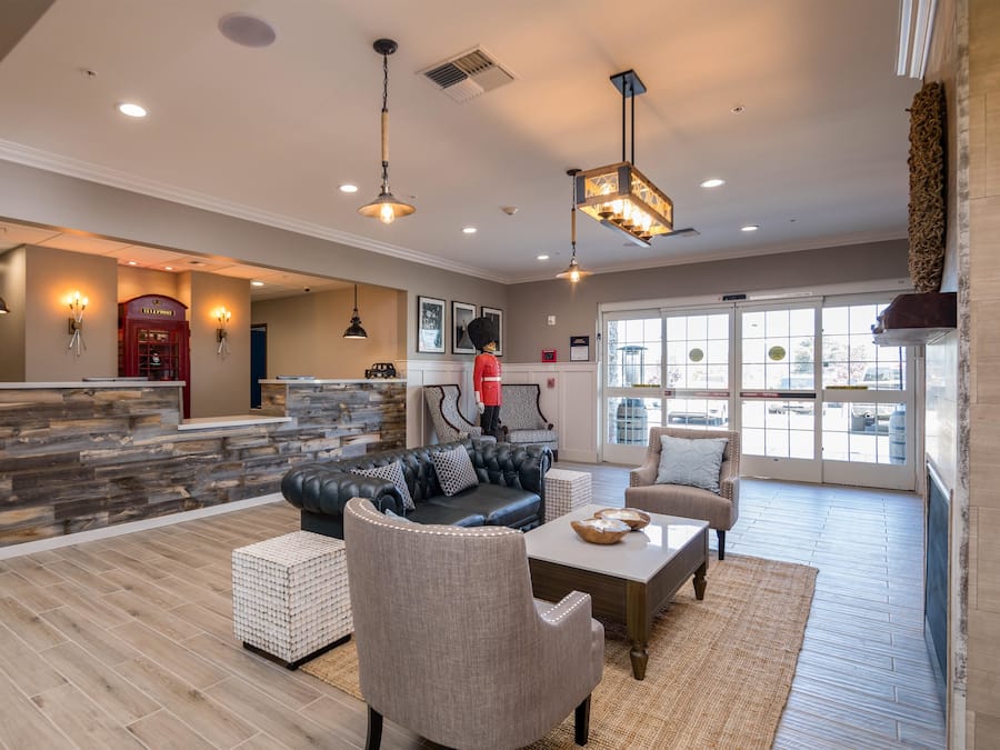A spacious living area with a stone accent wall, a leather sofa, and a coffee table.