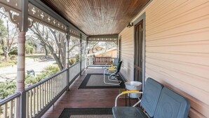 A covered porch with a wooden ceiling, a railing, and a bench. - Cyclismo - Suite 2 | Close to Main St. | Wonderful Porch (Fredricksburg)