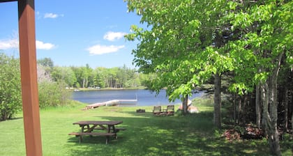 Lakefront, covered deck, huge backyard with grill, swimming, boat & kayaks!